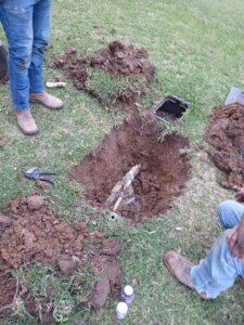 Repaired water supply line uncovered near the water meter in a Burleson, TX yard
