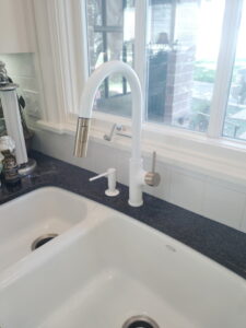 Installed Faucet and soap dispenser.