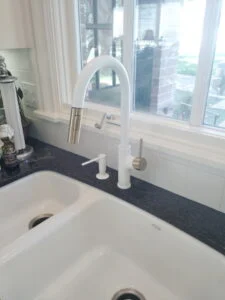 Installed Faucet and soap dispenser.