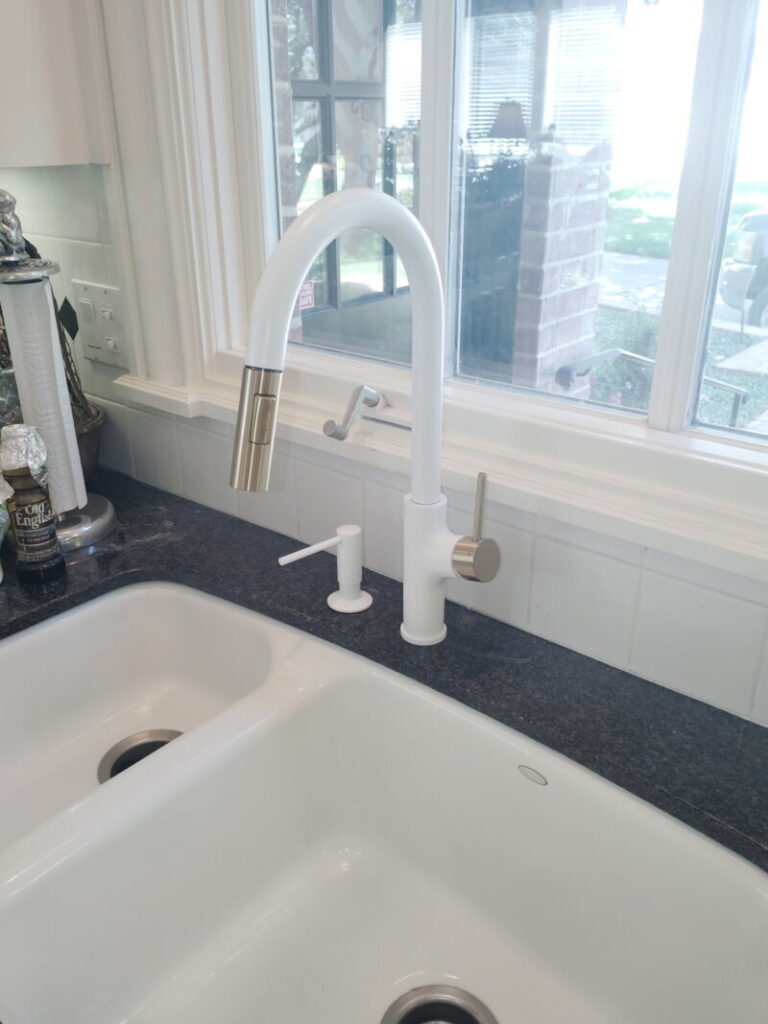 Installed Faucet and soap dispenser.