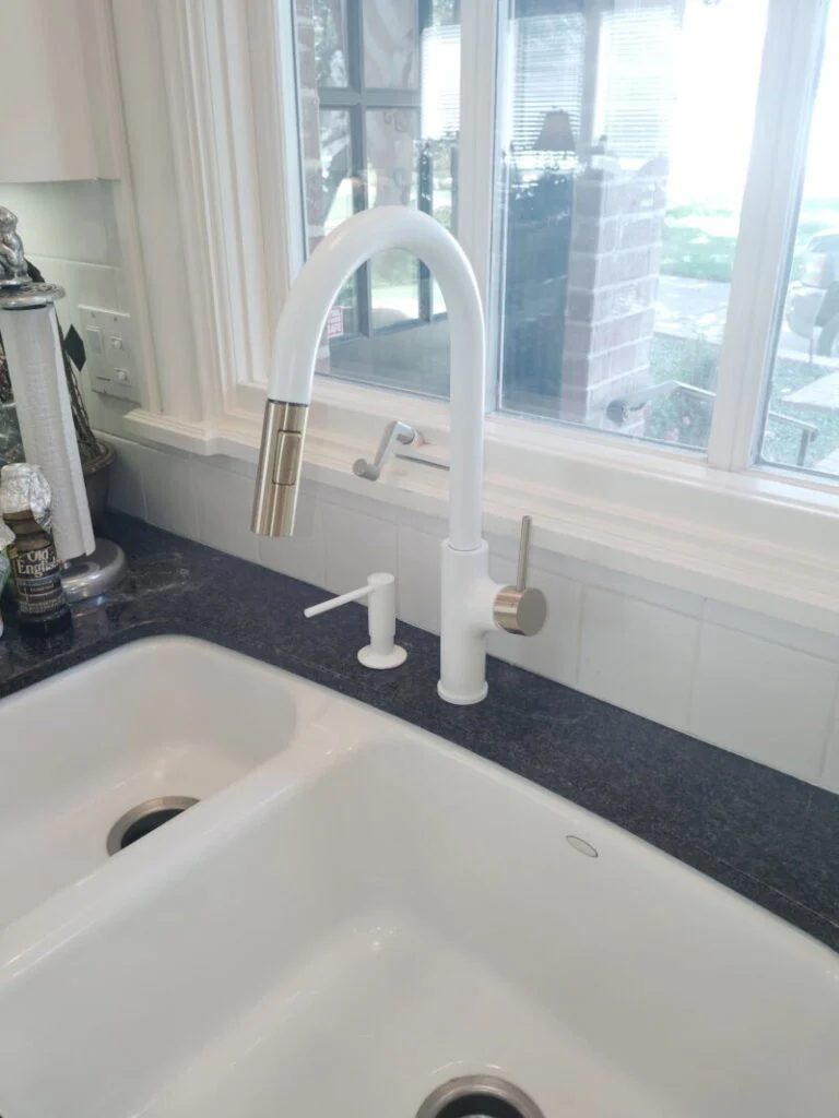 Installed Faucet and soap dispenser.
