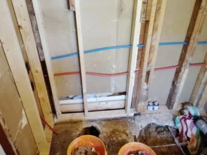 Bathtub drain relocated through an opened concrete slab with new water lines in a Burleson, TX bathroom remodel