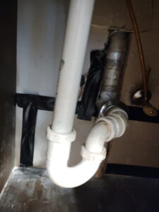 Rerouted and insulated hot water line run overhead through a wall cavity after a slab leak repair in Burleson, TX