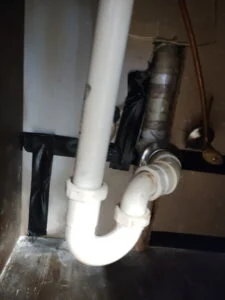 Rerouted and insulated hot water line run overhead through a wall cavity after a slab leak repair in Burleson, TX