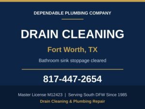 Plumber clearing a stopped up bathroom lavatory drain at a Fort Worth, TX home