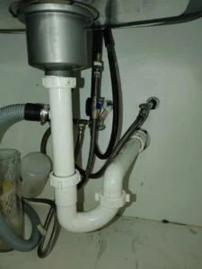 Repaired kitchen sink drain and P-trap under a sink in a Burleson, TX home